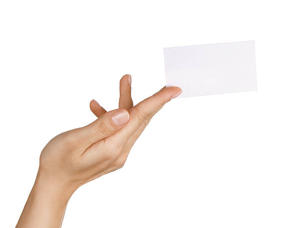 Blank business card in woman's hand Close up of female hand holding blank business card isolated on white background  telephone card stock pictures, royalty-free photos & images