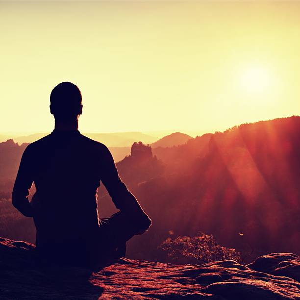 istock Hiker in squatting position on a rock, enjoy dybreak  scenery 491958894