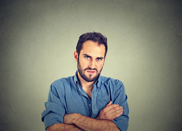 angry grumpy man, about to have nervous breakdown Closeup portrait of angry young man, about to have nervous breakdown, isolated on gray wall background. Negative human emotions facial expression feelings attitude impatient stock pictures, royalty-free photos & images