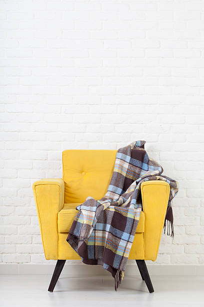 istock White wall texture with a retro armchair 491961284