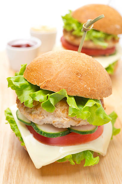 istock chicken burger with vegetables, cheese, ketchup and mustard 491962017