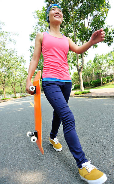 istock woman walking with a skateboard in hand 491962129