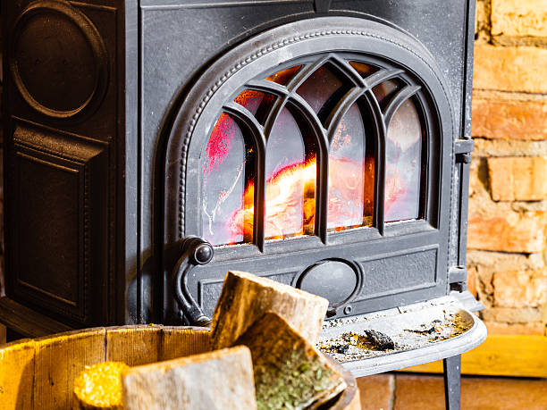 istock Fireplace with fire flame and firewood in barrel interior. Heating. 491962335