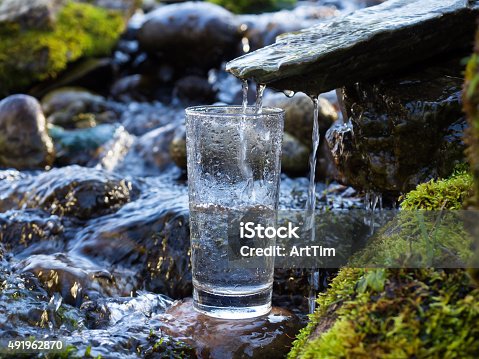 istock Mineral water is being poured into glass 491962870