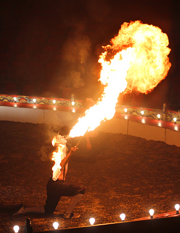 Professional circus performer breathes fire