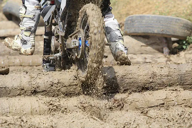 Enduro bike in obstacle log on track.