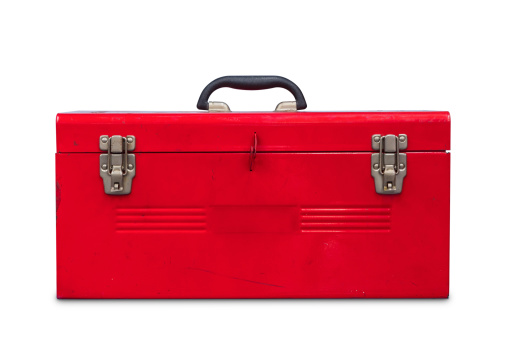 Old red steel toolbox, isolated on white background with clipping path