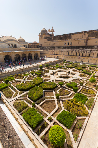 Jaipur, India - March 16, 2014: Tourists wander among the formal gardens within the Amber Fort at Jaipur, India