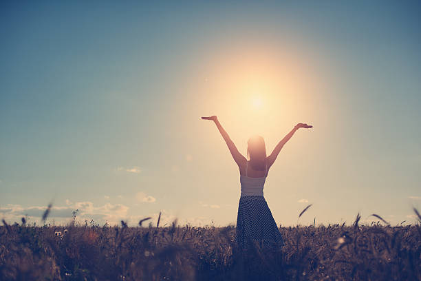 istock Girl with outspread hands in the field 491965672
