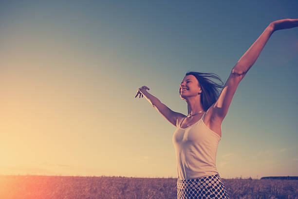 Girl enjoying sunset in the field