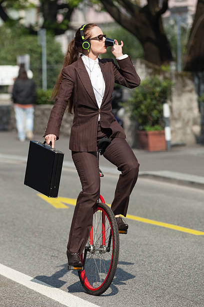 istock businesswoman with unicycle 491972226