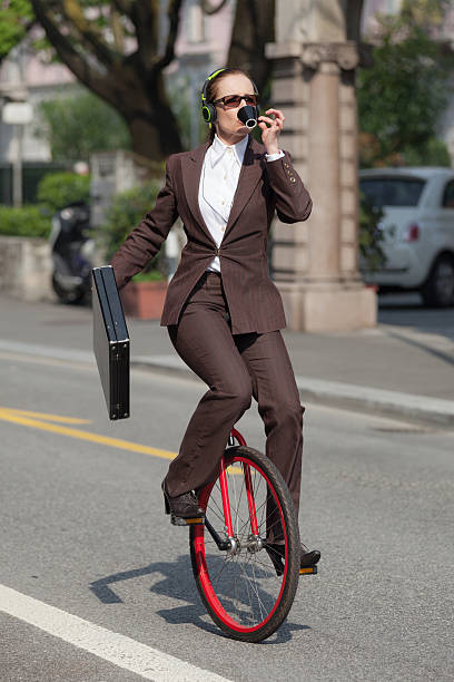 istock businesswoman with unicycle 491972522