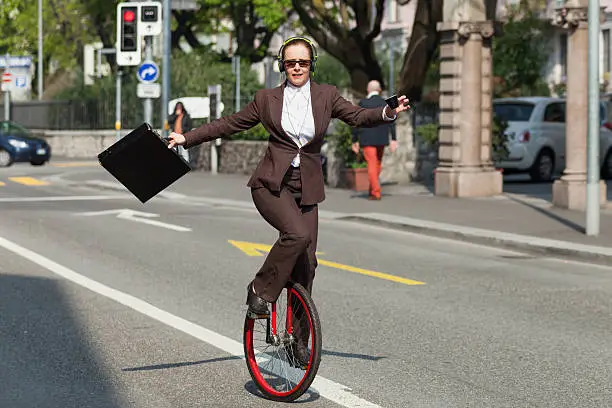 woman through the city with the unicycle to go to work