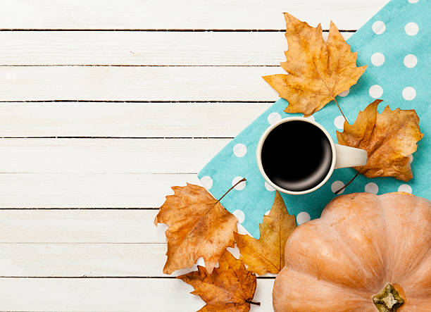 istock Cup of coffee and pumpkin with leafs 491973066
