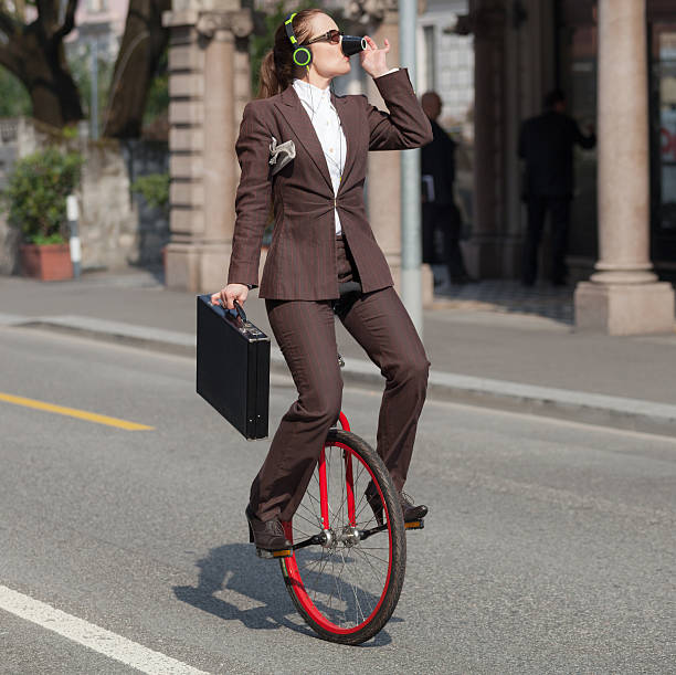 istock businesswoman with unicycle 491973674