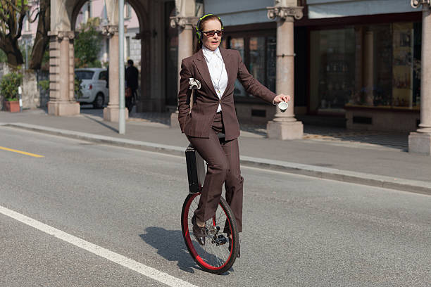 istock businesswoman with unicycle 491974086