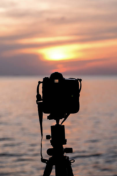 istock Silhouette of Digital camera beside sea at sunset time 491974522
