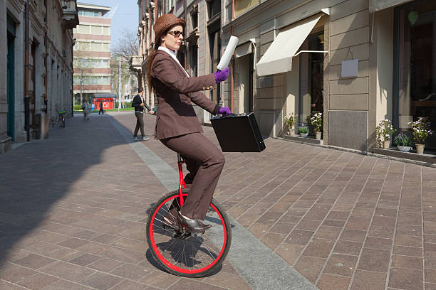 istock businesswoman with unicycle 491975618