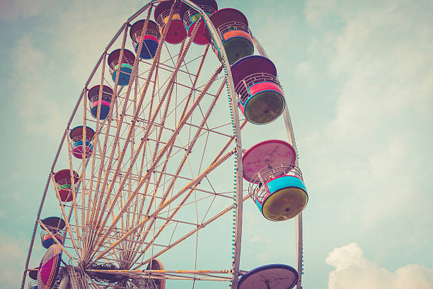 istock Ferris wheel on cloudy sky background vintage color 491976252