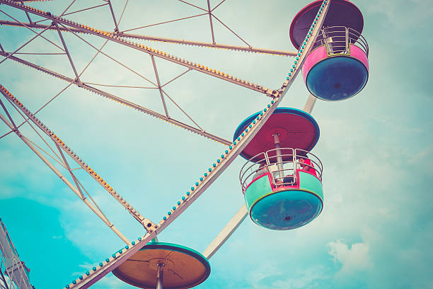 istock Ferris wheel on cloudy sky background vintage color 491976572