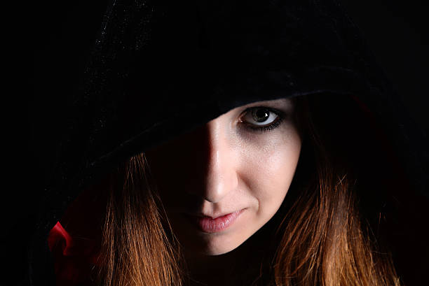 istock woman in black hood 491976722
