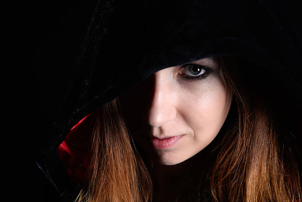 istock woman in black hood 491976748