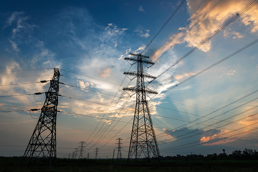 Electricity Pylon power line transmission tower at sunset