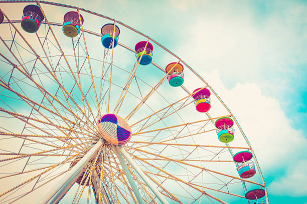 istock Ferris wheel on cloudy sky background vintage color 491977436
