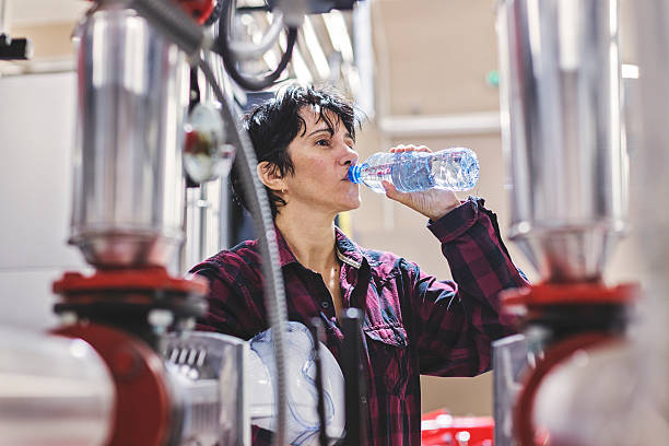 thursty female stationary engineer drinking water heat stress stock pictures, royalty-free photos & images