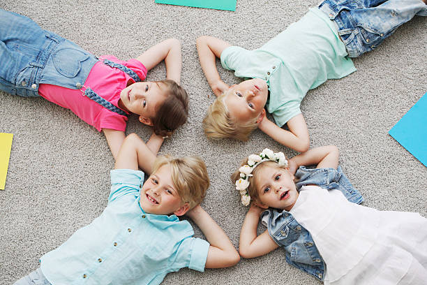istock happy kids lying on the floor 491979140