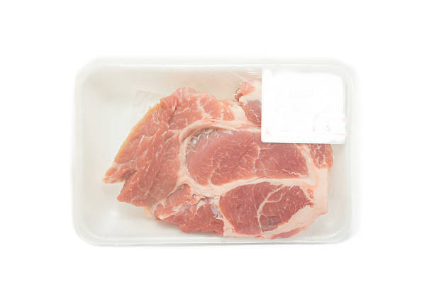 istock Raw pork  in packaging tray with price tag 491986274