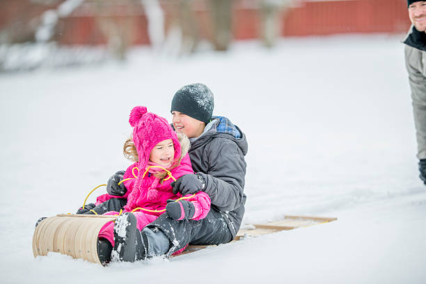istock Brother and Sister Playing in the Snow 491988162