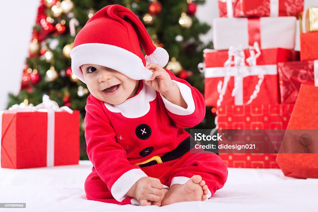 Funny smiling baby santa claus Funny smiling baby in santa claus costume 12-17 Months Stock Photo