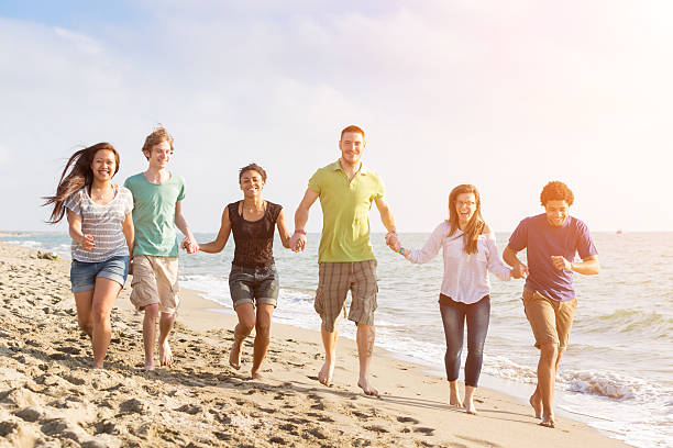 istock Multiracial Group of Friends Walking at Beach 491990543