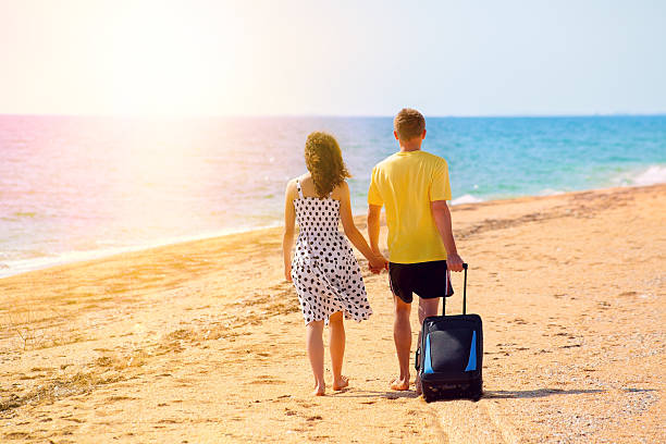 istock Young couple walking on the beach 491991443