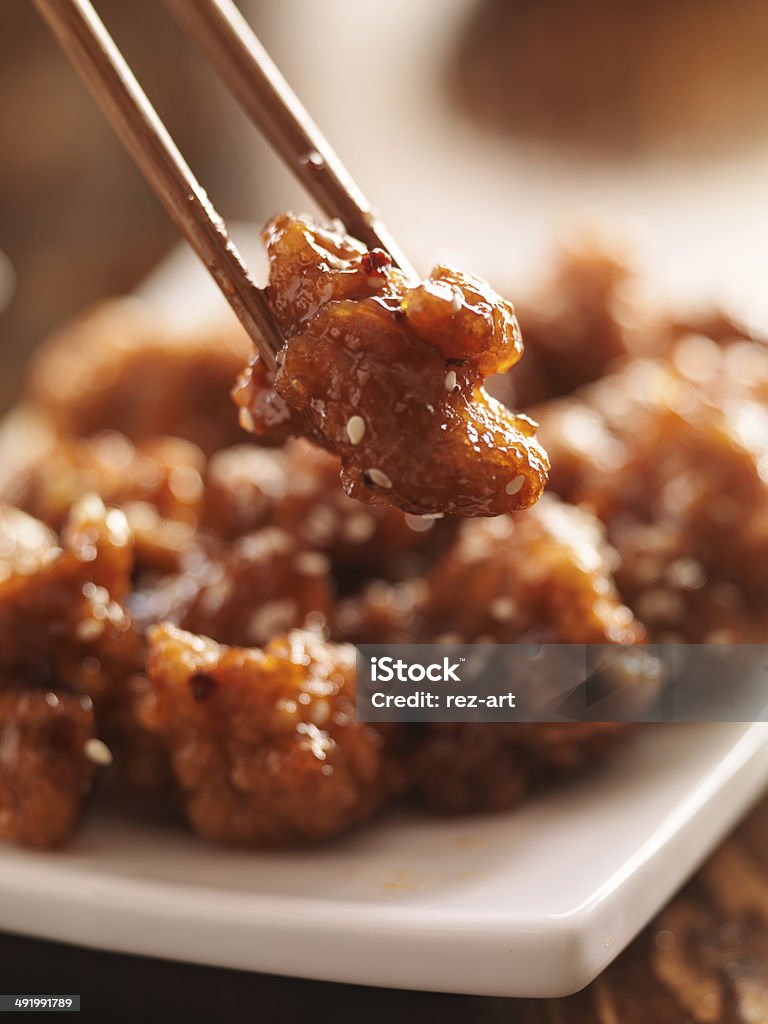 eating chinese chicken with chopsticks eating chinese chicken with chopsticks, shot with selective focus Asia Stock Photo