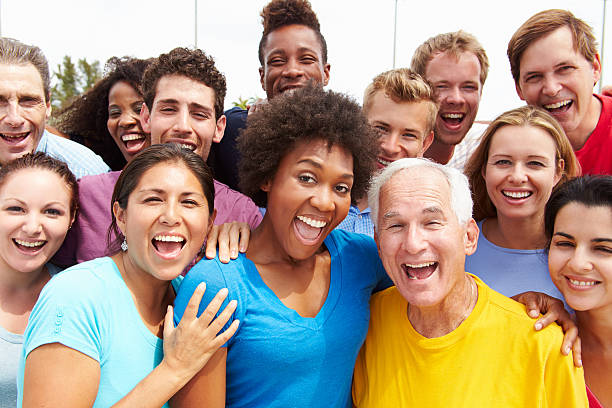 Outdoor Portrait Of Multi-Ethnic Crowd Outdoor Portrait Of Multi-Ethnic Crowd Smiling To Camera cheering photos stock pictures, royalty-free photos & images