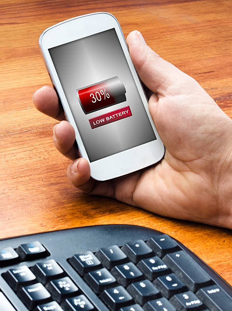 istock smartphone with a low battery icon in the screen 491993160