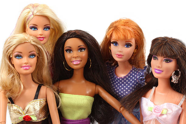 Group of Barbie dolls posed together stock photo