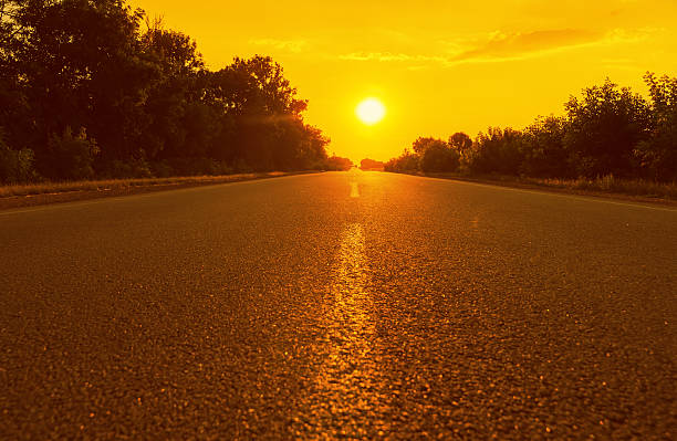 istock orange sunset and asphalt road 491993568