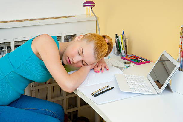 istock teen girl sleeping at her study desk 491994545
