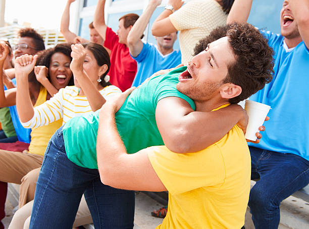 istock Sports Spectators In Team Colors Celebrating 491995013