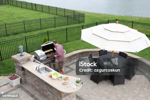 istock Man cooking meat on a gas BBQ 491995831