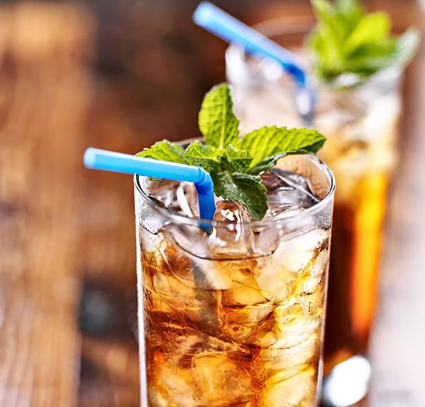 istock iced tea with blue straw and mint garnish 491996609