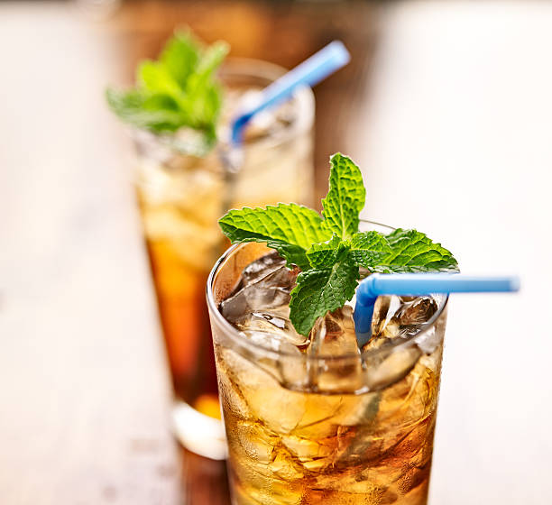 istock iced tea with blue straw and mint garnish 491996665