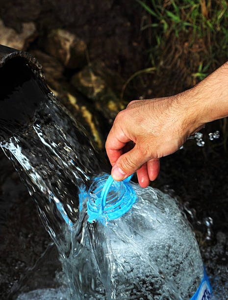 istock male hand holding a water bottle 491997007