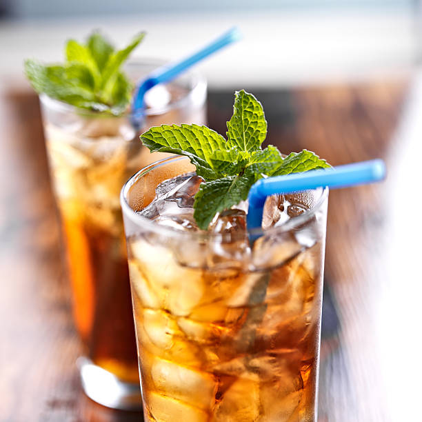 istock iced tea with blue straw and mint garnish 491997095