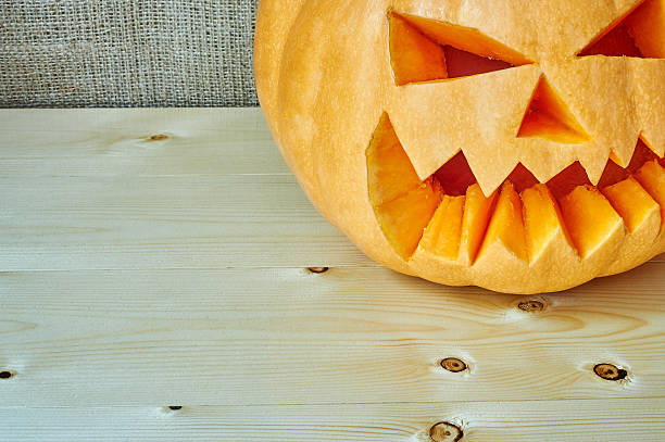 istock Halloween orange pumpkin on a wooden background 492002358