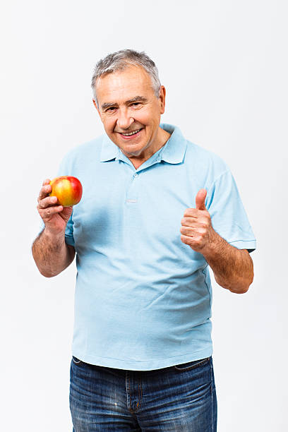 istock Thumbs up for healthy snack for senior man 492002520