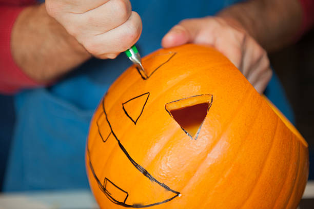istock man prepares a pumpkin for Halloween 492004118